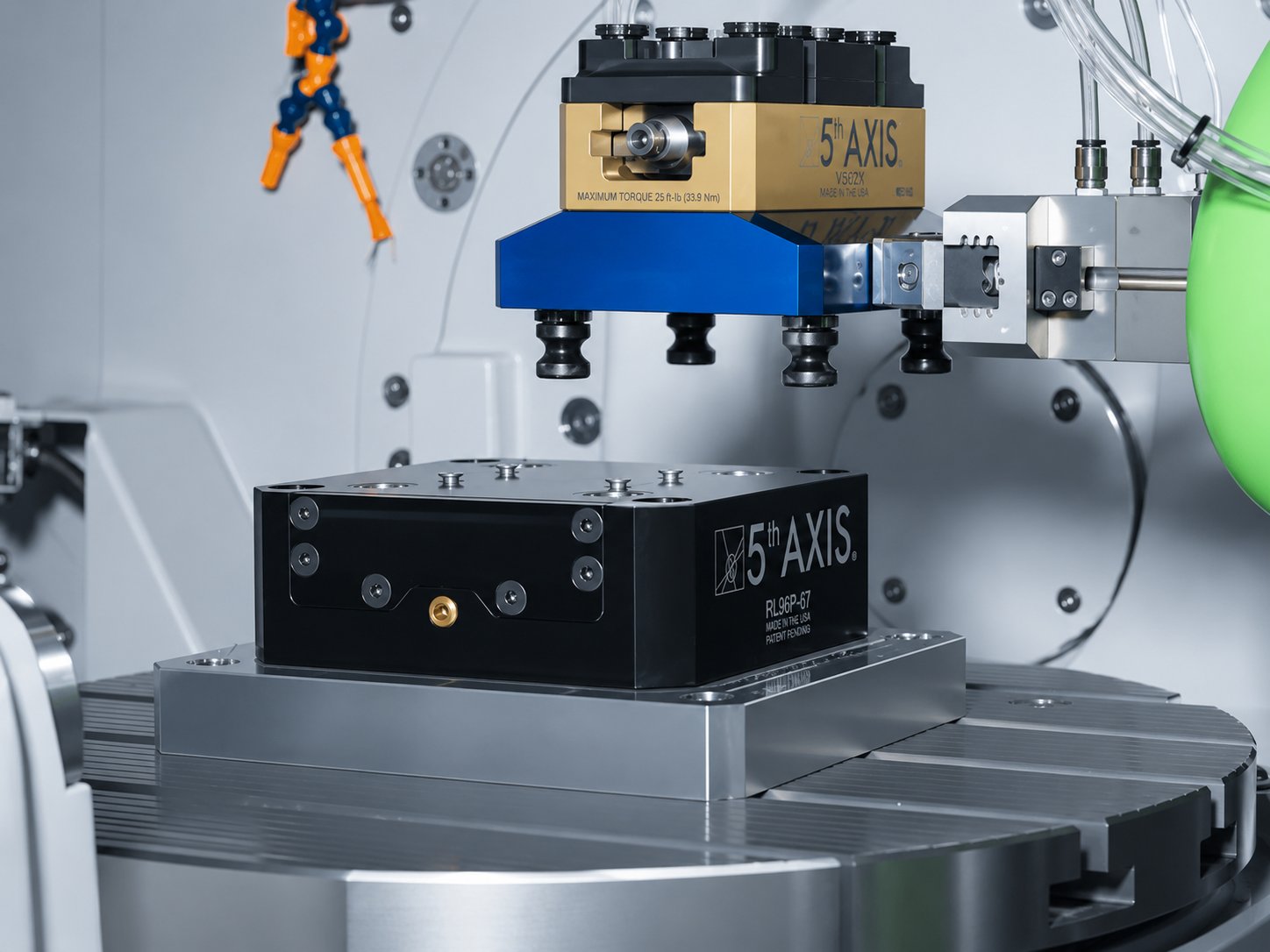 V562X vise in robot gripper above an RL96P-67 receiver chuck inside a machining cell